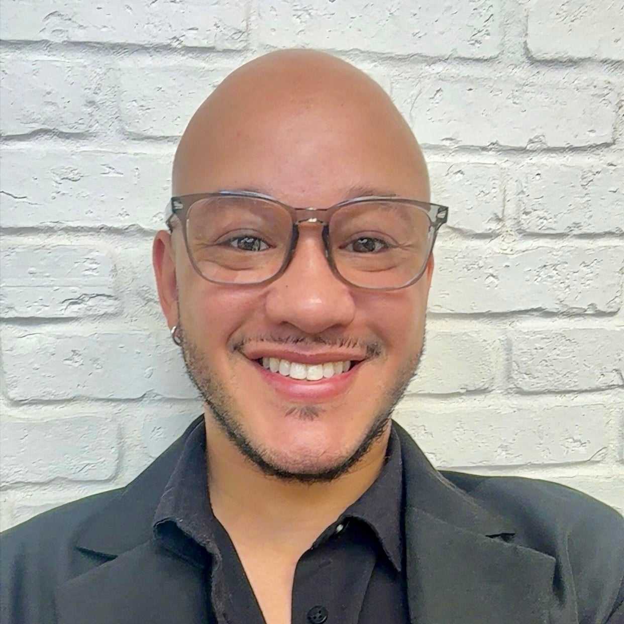 Portrait of Charlie, a professional stylist at Hudson Salon, showcasing their expertise and style.
